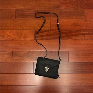 Moda Luxe Black Clutch with Tassel Accent and shoulder strap